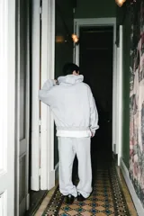 Pantalon de jogging color gris melange, de corte holgado con cintura elástica, cordón ajustable y cordones en los tobillos para regular el ancho.