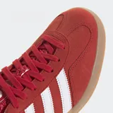 Championes Adidas Gazelle Indoor color rojo con detalles en blanco y suela color caramelo.