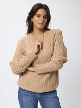 Sweater de tejido de punto con diseño de ochos, cuello redondo y mangas largas con puños acanalados.