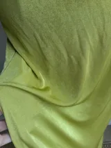 Conjunto de dos piezas color verde oliva, compuesto por un top con escote profundo y diseño cruzado, y una falda midi ajustada de tiro alto.