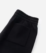 Pantalón jogger de algodón con felpa, color negro, con cintura elástica, cordón ajustable, bolsillos laterales y puños elásticos en los tobillos.