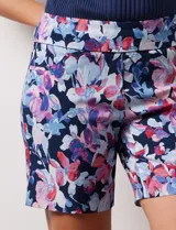 Short de gabardina elastizada con estampado floral en tonos azules, rosas y violetas. Pretina ancha elastizada y bolsillos delanteros.