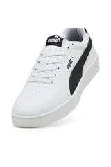 Championes Puma Court Classic Clean, color blanco con la icónica franja lateral de Puma en color negro. Diseño urbano con suela de goma y detalles de la marca en la lengüeta y el talón.