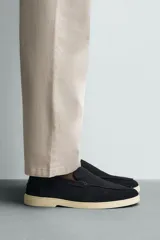 Mocasín casual de hombre, color azul marino, con parte superior de serraje (gamuza) y suela de goma a contraste color beige. Presenta un detalle de bordón cosido en la pala.