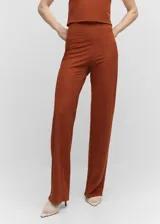 Pantalón de punto estilo wideleg, de tiro alto y corte largo, con cierre lateral de cremallera.