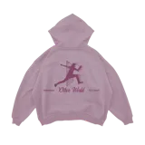 Hoodie rosado pastel de algodón con capucha, cordón ajustable y bolsillo canguro. Estampado en la espalda con la silueta de una persona saltando a través de un portal, el texto "Other World" y la leyenda "Est 2022".