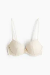 Soutien push-up color beige con encaje y malla, diseño bordado, aros, breteles ajustables y copas acolchadas. Cierre de corchetes en la espalda.