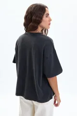 Remera negra de manga corta, corte holgado y diseño boxy. Presenta un estampado frontal de dos tigres enfrentados rodeados de flores, con la frase "BRILLENT POUR TOUJOURS PARIS, 1986".