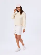 Buzo de piqué color beige, de manga larga, cuello redondo y diseño liso.