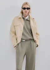 Pantalón verde militar de corte recto y tiro alto, con bolsillos laterales y pinzas frontales.