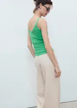 Top de punto fino color verde, con tirantes finos y cuello en pico, de diseño entallado y sin mangas.