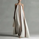 Vestido maxi largo a rayas verticales en tonos celeste, marrón y tostado, con tirantes finos regulables y corte holgado.