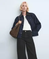 Jeans wide leg negros de tiro medio, con diseño de pernera ancha y terminación desmechada en el bajo.