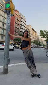 Pantalón cargo oversize de jean con múltiples bolsillos funcionales y detalles metálicos en bronce.