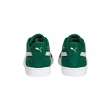Championes Puma Suede Classic color mostaza con franja lateral blanca y suela blanca.