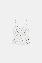 Top peplum de escote corazón con tirantes finos, con estampado de lunares y detalle de lazos frontales.