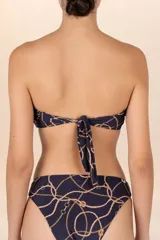 Top de bikini bandeau azul oscuro con estampado de cadenas doradas, breteles removibles y detalle cruzado en el frente.