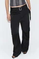 Pantalón cargo de tiro medio confeccionado en tejido satinado. Presenta bolsillos laterales con solapa, corte recto y holgado, y un cinturón integrado del mismo tejido con hebilla metálica.