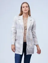 Blazer de tejido soft con estampado a cuadros en tonos blanco, beige y gris. Presenta cuello solapa, abertura frontal y bolsillos delanteros.