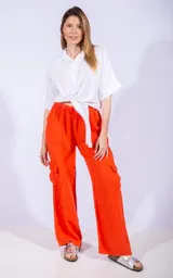 Pantalón amarillo de tiro alto, corte ancho, con bolsillos laterales tipo cargo y cintura con cordón ajustable.