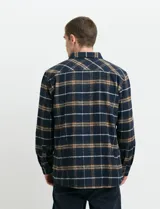 Sobrecamisa de manga larga con diseño a cuadros, cuello camisero y bolsillo frontal. Confeccionada en tejido de poliéster y algodón, sin forro.