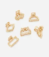 Kit de 6 pirañas para el pelo pequeñas en metal con baño color oro. Incluye diseños variados: lazo, caracola, gato, media luna, rectángulo y forma geométrica, todos con estructura ahuecada y dientes metálicos para una fijación segura.