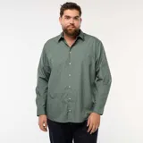Camisa de corte recto y manga larga, color verde con estampado de pequeños puntos blancos. Presenta cuello clásico y cierre frontal con botones.