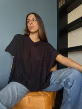 Chaleco tejido de punto en color marrón, con diseño de trenzas y ochos, escote en V y silueta oversize.