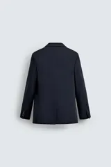 Blazer de corte regular confeccionado en lana de origen italiano. Presenta cuello con solapas de muesca, cierre frontal de un botón, bolsillos laterales con solapa y bolsillo de vivo en el pecho. Incluye abertura central en la espalda y forro interior.