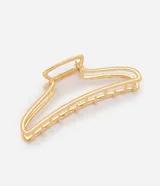 Pinza para el pelo de metal dorado con diseño calado en forma de media luna y estructura alargada con varillas paralelas.