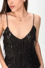 Vestido corto negro con tirantes finos, escote en V y diseño completamente revestido de flecos brillantes.