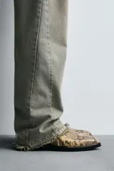 Botín de cuero con estampado de serpiente, corte a la altura del tobillo, punta fina, cierre lateral con cremallera y tacón bajo.