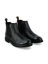 Botín Chelsea negro de mujer, caña corta, con elástico lateral liso y un panel trasero con textura de cocodrilo. Posee suela de goma gruesa y tirador trasero para calzar.