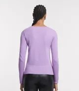 Suéter de punto color rosado, con cuello barco, mangas largas y puños con botones decorativos. El dobladillo también es acanalado.