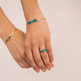 Brazalete abierto dorado con piedras rectangulares de jade negro azul.