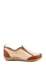 Zapato de cuero artesanal en color beige y marrón, con diseño calado y cierre lateral oblicuo.