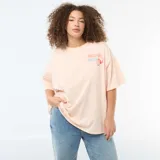 Remera oversize de manga corta color salmón con estampado frontal que incluye texto y gráfico de naranjas.