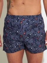 Bóxer de algodón blanco con estampado de flores pequeñas color celeste, con cintura elástica y logo de la marca en el centro.