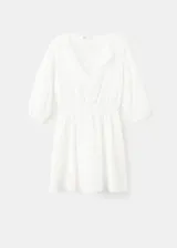 Vestido corto blanco de algodón con diseño broderie, escote en V con solapa, mangas cortas abullonadas y cintura elástica fruncida.