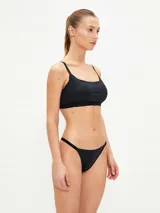 Top de bikini negro de corte recto, con tirantes finos ajustables y banda elástica inferior.