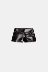 Shorts de tiro medio con efecto de cuero brillante en color negro, con cierre frontal y detalles de botones en la cintura.