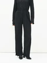 Pantalón negro plisado de corte palazzo con cintura elastizada.