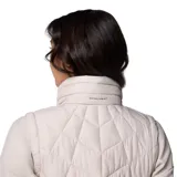 Chaleco acolchado Columbia Heavenly II, color gris claro, con cierre frontal de dos vías, cuello alto forrado en felpa y bolsillos laterales con cierre. Presenta tecnología Omni-Heat™ para retención de calor y Omni-Shield™ para repeler humedad.