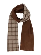 Bufanda de diseño reversible, con un lado en color marrón liso y el otro lado con estampado de cuadros en tonos beige y marrón. Presenta bordes desflecados y una pequeña etiqueta decorativa.