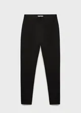 Pantalon skinny de tiro medio, confeccionado en tejido elástico con cintura con goma elástica y diseño entallado.