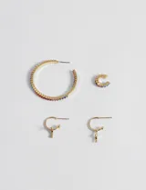 Set de aros dorados con strass multicolor, compuesto por un aro argolla grande, un aro argolla pequeño tipo cuff y un par de aros mini con dije colgante.