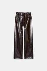 Pantalón de tiro alto con diseño de pernera recta y cinco bolsillos. Confeccionado en material con acabado efecto piel y textura de grabado animal, cuenta con cierre frontal mediante cremallera, botón interior y gancho.