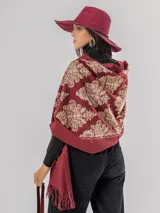 Pashmina bordada en color bordó con detalles en hilo de lurex dorado y bronce, con terminación de flecos en los extremos.