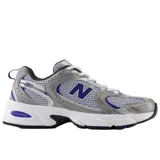 Championes urbanos New Balance modelo 530, con diseño retro de malla blanca y superposiciones en color plata y detalles en azul. Cuenta con entresuela con tecnología ABZORB para mayor amortiguación.
