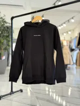 Canguro oversize marrón con capucha, bolsillo tipo canguro y diseño estampado en la espalda con el texto "Be Brave" y detalles tipográficos en color blanco.